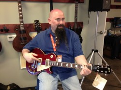 Holding the Gibson Lucy guitar
